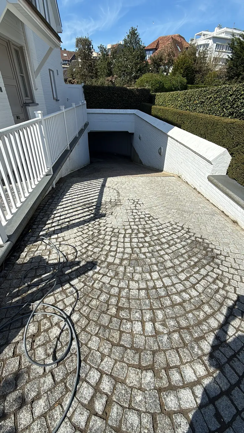 Reiniging van de oprit naar een garage en van een buitentrap.